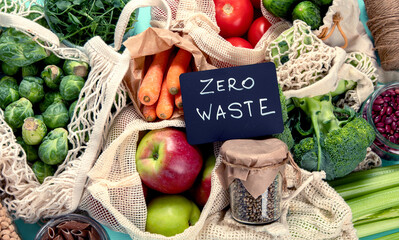 Various organic fruits and vegetables in reusable packaging bags.