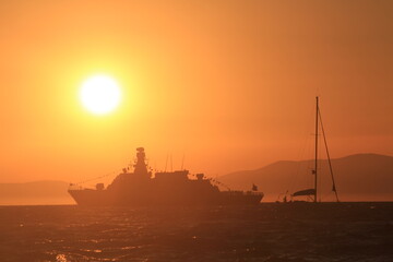 Fototapeta na wymiar Sunset over the sea and a ship