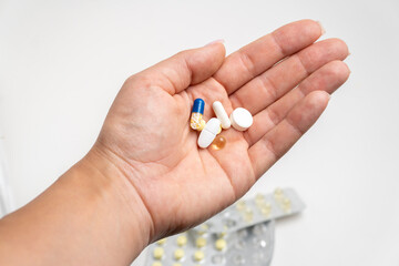 Handful of pills in hand
