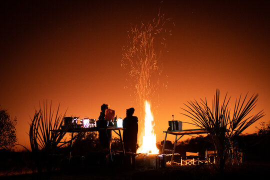 Bonfire and campfire cooking at sunset in the magical Okavango Delta in Botswana. Taken on a Trans Okavango wilderness boat safari in July 2022.