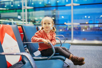 Adorable little preschooler girl traveling by plane