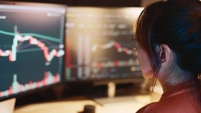 Closeup - Woman is checking Bitcoin price chart on digital exchange on computer, cryptocurrency future price action prediction.