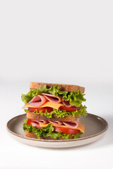 Club sandwich with ham, cheese, tomato and lettuce. 