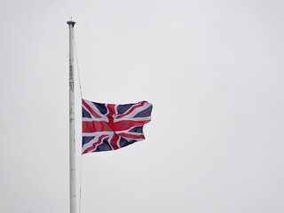 British United Kingdon English country flag at half-mast - obrazy, fototapety, plakaty