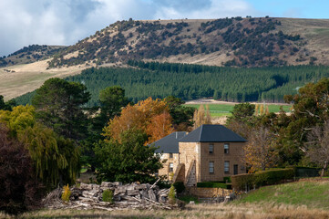 Fototapeta na wymiar Ouse Australia, view across valley with stone farmhouse in foreground