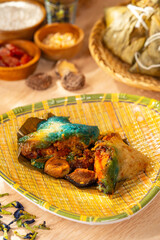 Zongzi or Bakcang is a traditional Chinese rice dish made of glutinous rice stuffed with different fillings and wrapped in bamboo leaves. They are cooked by steaming or boiling