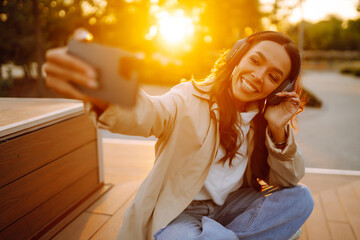 Selfie time. Young woman taking selfie photo at sunset. .Lifestyle, youth, travel, tourism.