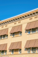 Exterior of residential building in Tucson Arizona with awnings on the windows