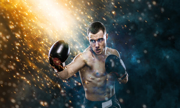 The Boxing. Sportsman muay thai boxer fighting in gloves. Isolated on black background with smoke and sparks. Copy Space.