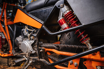 suspension with shock absorber and wheel close-up on a sports off-road custom motorcycle