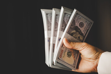 Banknote of 100 dollar bills in hands of rich woman person. Success business female holding cash...