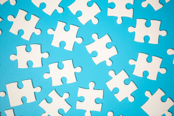 White part of jigsaw puzzle pieces on blue background. concepts of problem solving, business success, teamwork, Team playing jigsaw game incomplete, Texture photo with copy space for text