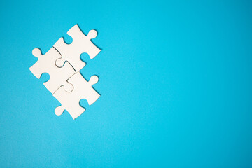 White part of jigsaw puzzle pieces on blue background. concepts of problem solving, business success, teamwork, Team playing jigsaw game incomplete, Texture photo with copy space for text