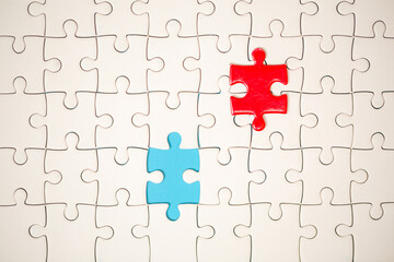 White part of jigsaw puzzle pieces on blue background. concepts of problem solving, business success, teamwork, Team playing jigsaw game incomplete, Texture photo with copy space for text