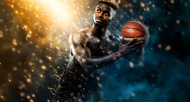 Portrait Of Afro-american Sportsman, Basketball Player With A Ball Over Black Background. Fit Young Man In Sportswear Holding Ball.