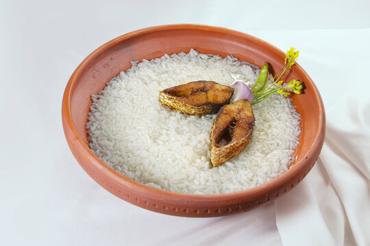 Panta ilish Bengali new year festive dish. Boishakh panta ilish with chilli and onion. Panta bhat is popular among Bengali's in India and Bangladesh. Hilsha fry into clay plate bowl shanki or sanki.
