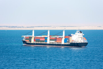 Fototapeta premium Fully loaded, cargo container ship entering Suez Canal.
