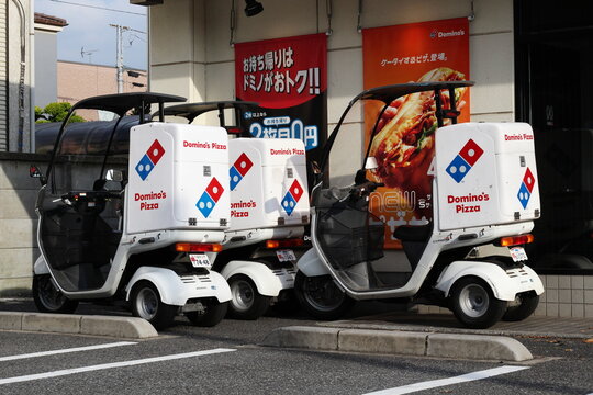 CHIBA, JAPAN - July 13, 2018:  Delivery bikes outside Domino's Pizza restaurant in Chiba City.