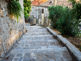 Stone steps in a charming narrow steep pedestrian street leading to Dubrovnik old town. Croatia, Europe