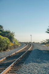 Railroad track on rocky land against sky at Del Mar Southern California