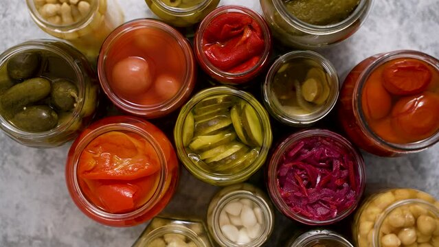 Preservation of vegetables in glass jars. Tomatoes, cucumbers, mushrooms, cabbage, pepper