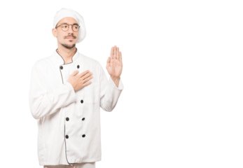 Serious young chef with a gesture of oath