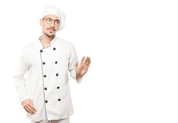 Doubtful young chef doing a gesture of keep calm