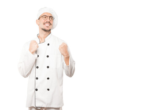 Upset young chef doing a competitive gesture
