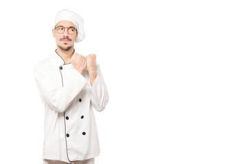 Serious young chef making a gesture of strength