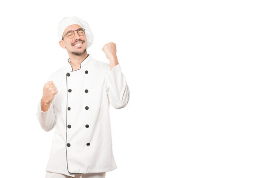 Competitive young chef making a gesture of celebration