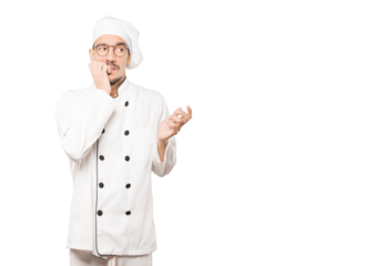 Crazy young chef making a nervous gesture