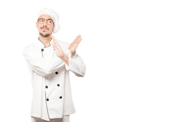 Young chef making a gesture of not crossing with the arms