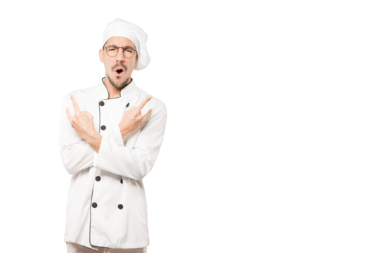 Naughty young chef making a rock gesture