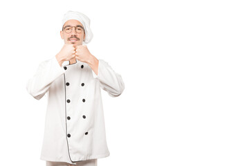 Young chef making a gesture of team work with his hands