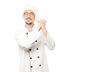 Young chef making a gesture of team work with his hands