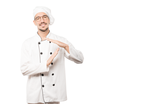 Stressed young chef making a time out gesture with his hands