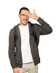Student covering his eyes with his hands