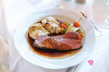 Delicious dinner beautifully arranged on a dinner plate.