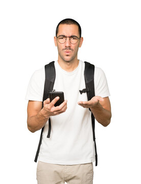 Concerned young studen using his smartphone