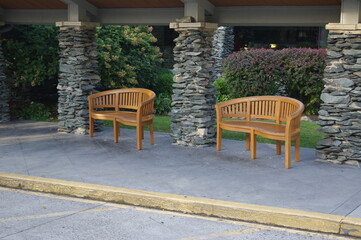 Obraz premium Wood benches between stacked stone columns