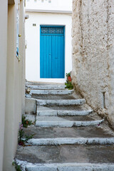 Narrow and colorful street in the village of Kritsa in the island of Crete. White street, beautiful traditional housing in Greece. 