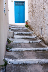 Narrow and colorful street in the village of Kritsa in the island of Crete. White street, beautiful traditional housing in Greece. 