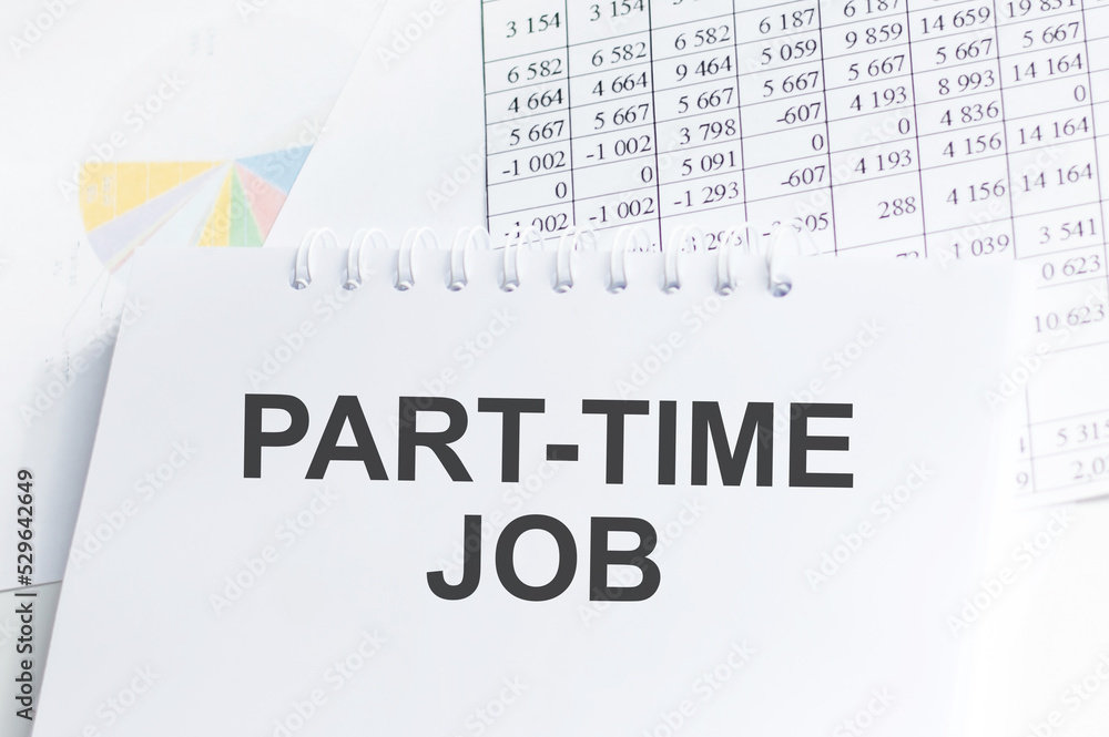 Poster part-time job text on notepad on the table among reports and charts