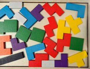 Randomly laid out multi-colored puzzle on a wooden board
