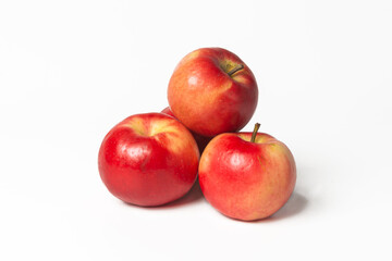 Fototapeta na wymiar Three organic red-yellow small apples on a white isolated background