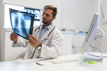  pulmonologist Doctor looks at a chest x-ray - clinic medical concept