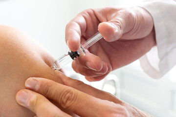 Doctor injecting vaccine for flu or coronavirus like the Covid-19