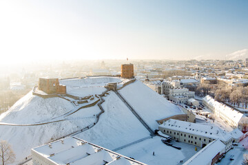 Aerial Vilnius city panorama in winter with snow covered houses, churches and streets. Gediminas...