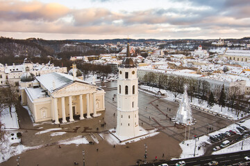 Aerial Vilnius city panorama in winter with snow covered houses, churches and streets. Cathedral square and Christmas tree. Winter city scenery in Lithuania.
