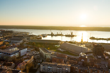 Scenic aerial view of Klaipeda city port area and it's surroundings on chilly autumn day. The Old town of Klaipeda, Lithuania in golden evening light.